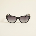 Sylvie gradient cat-eye sunglasses in black with smoke lenses, against a cream studio backdrop