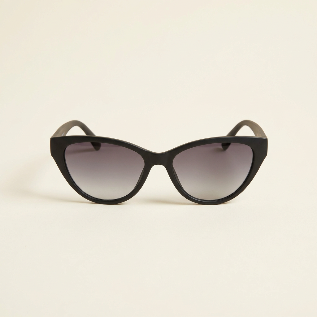 Sylvie gradient cat-eye sunglasses in black with smoke lenses, against a cream studio backdrop